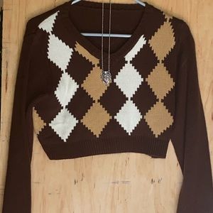 brown hoodie with a necklace